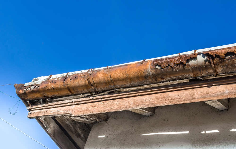 very old, rusty gutters with cracks on them