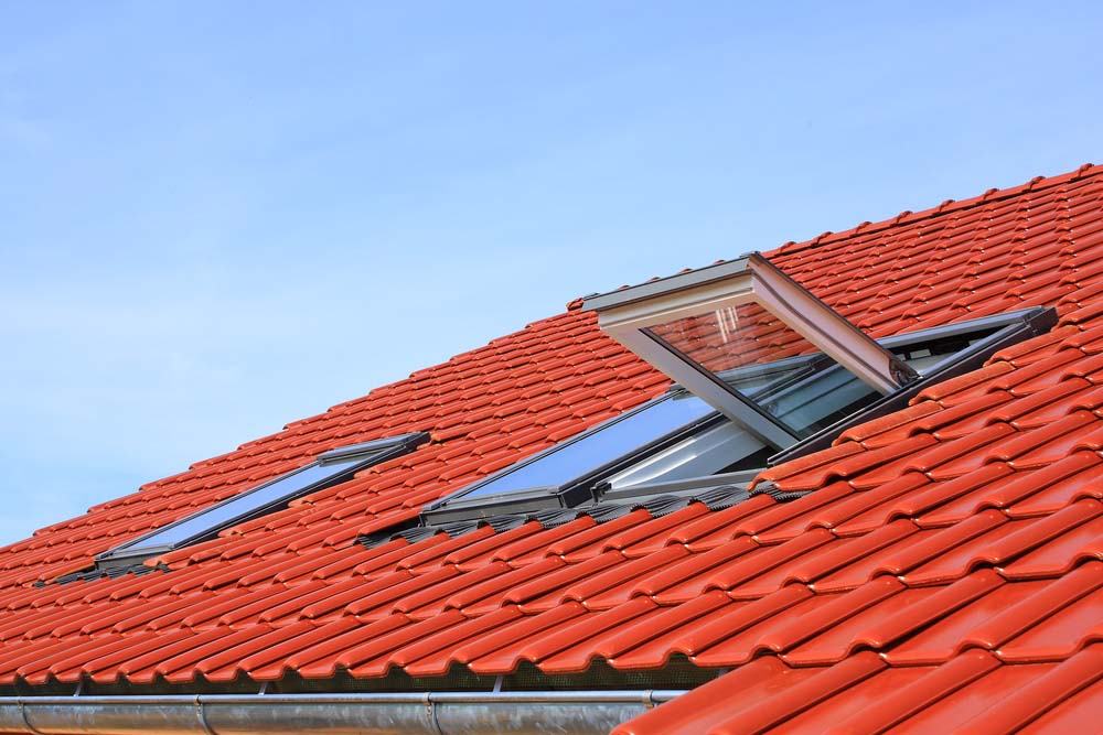 a red metal roof with skylights