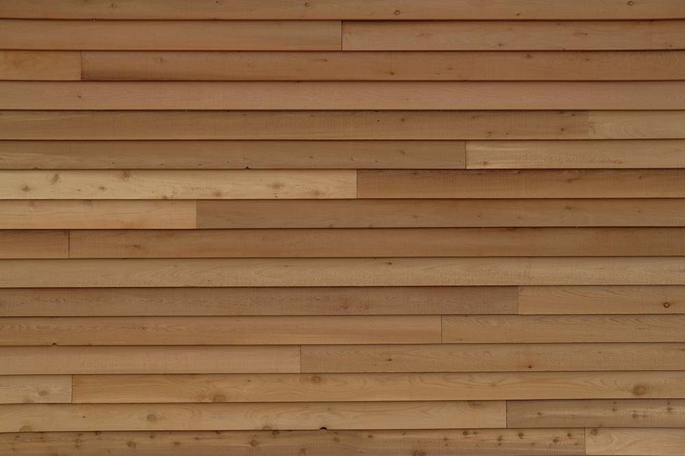 A close-up of natural wood siding on the exterior of a house.