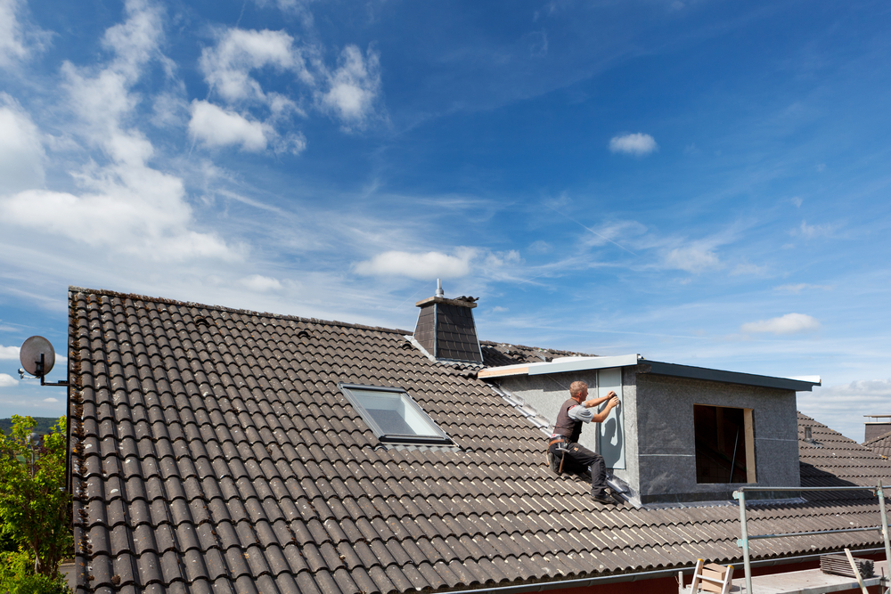 a roofer working on a tile roof