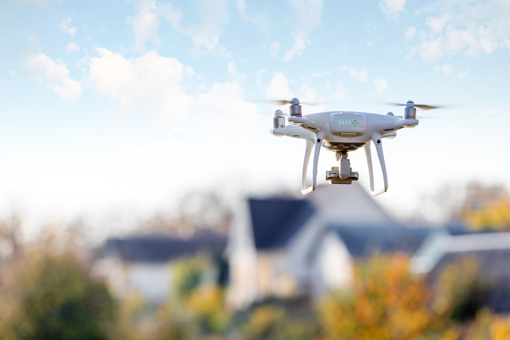 a drone flying above a suburban area