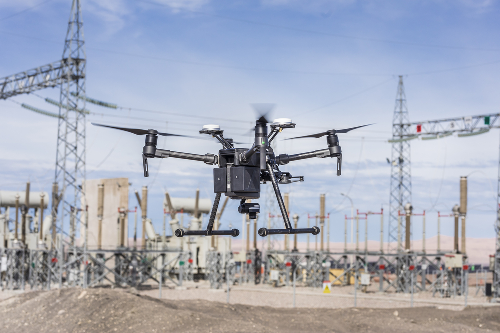 a drone flying in front of power lines
