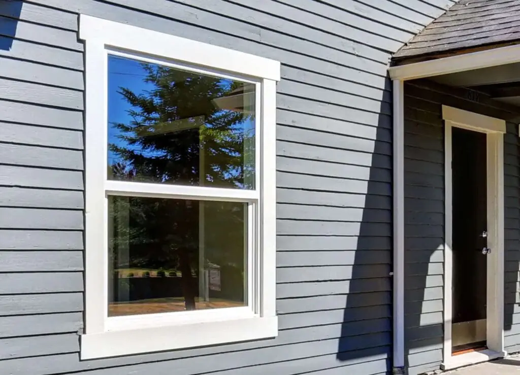 White replacement windows installed on a two-story home in Kernersville, NC